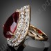 Кольцо с огромным красным камнем, усыпанным вокруг множеством мелких кристаллов сваровски, покрытое золотом